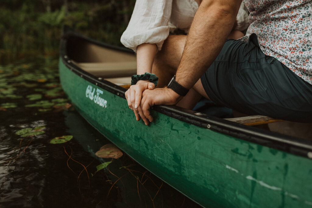 Couple canoeing on a pond